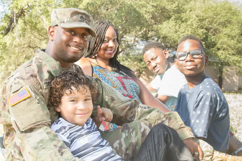 Military man in uniform with his family