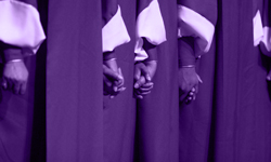 close-up of choir members in robes holding hands