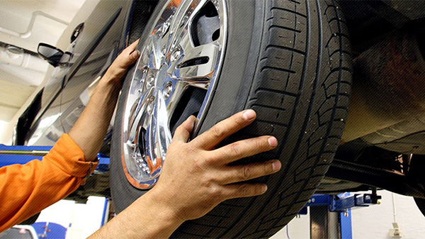 Closeup of mechanic changing a tire